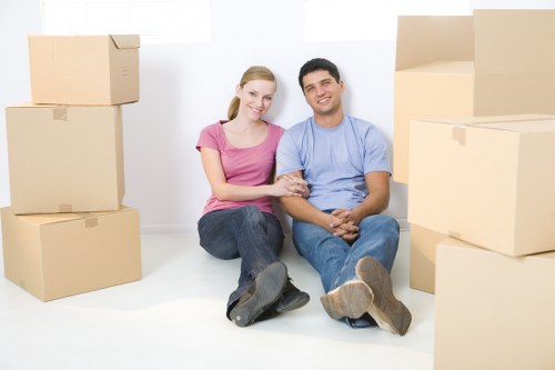Movers handling desks and IT equipment during an office move
