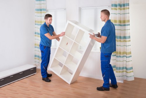 Professional movers preparing furniture and boxes for transport in Battersea